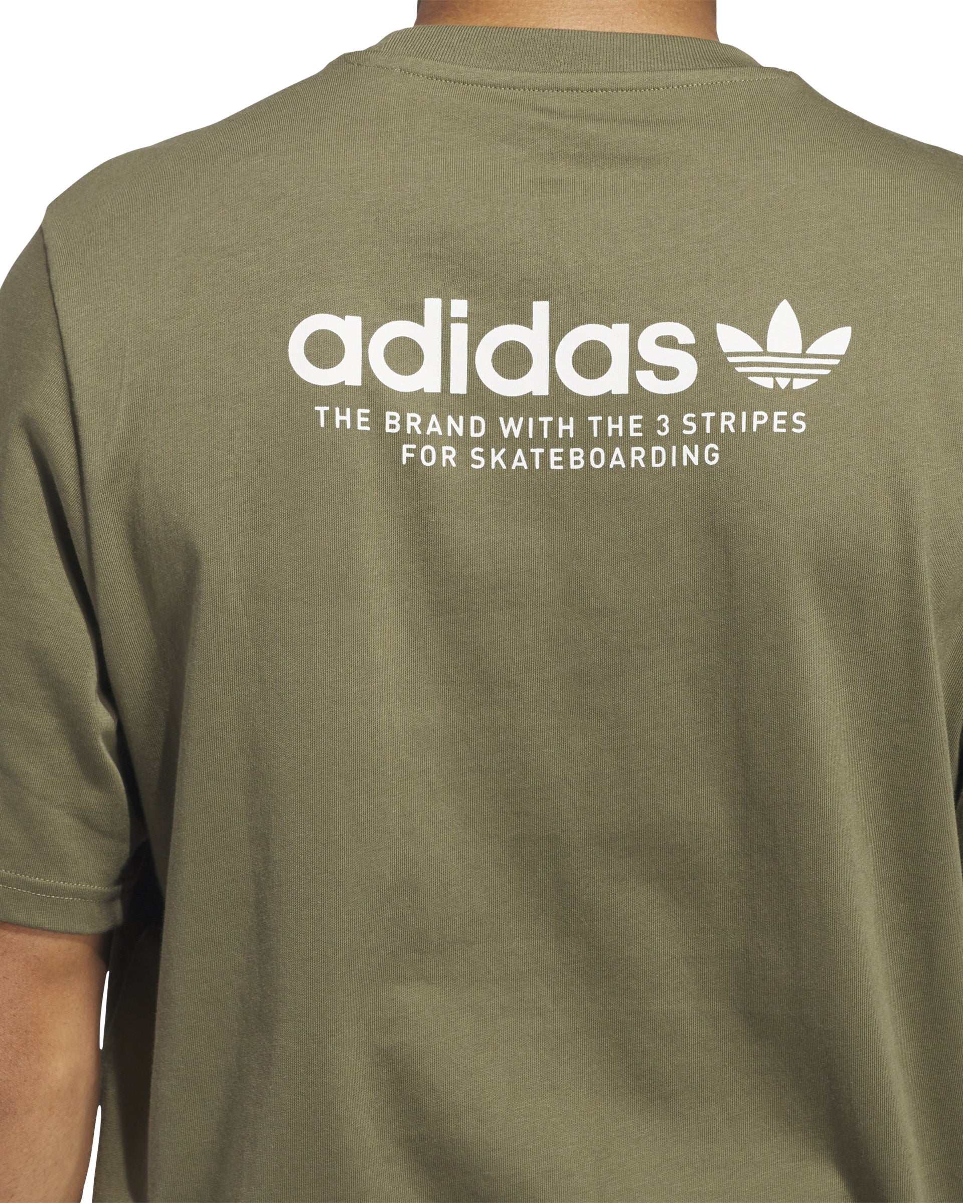 Close-up of the back of an olive green Adidas t-shirt featuring a white logo and 'The Brand with the 3 Stripes' text.