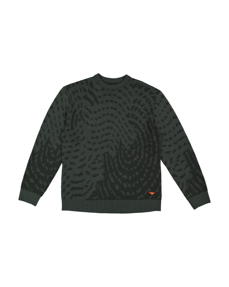 Front view of dark green knit jumper with abstract swirl pattern and small logo on hem.