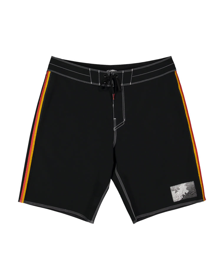 Black boardshorts with yellow and red stripes down each side and contrast white stitching, featuring a front tie waist and a monochrome palm tree patch on the lower left leg.