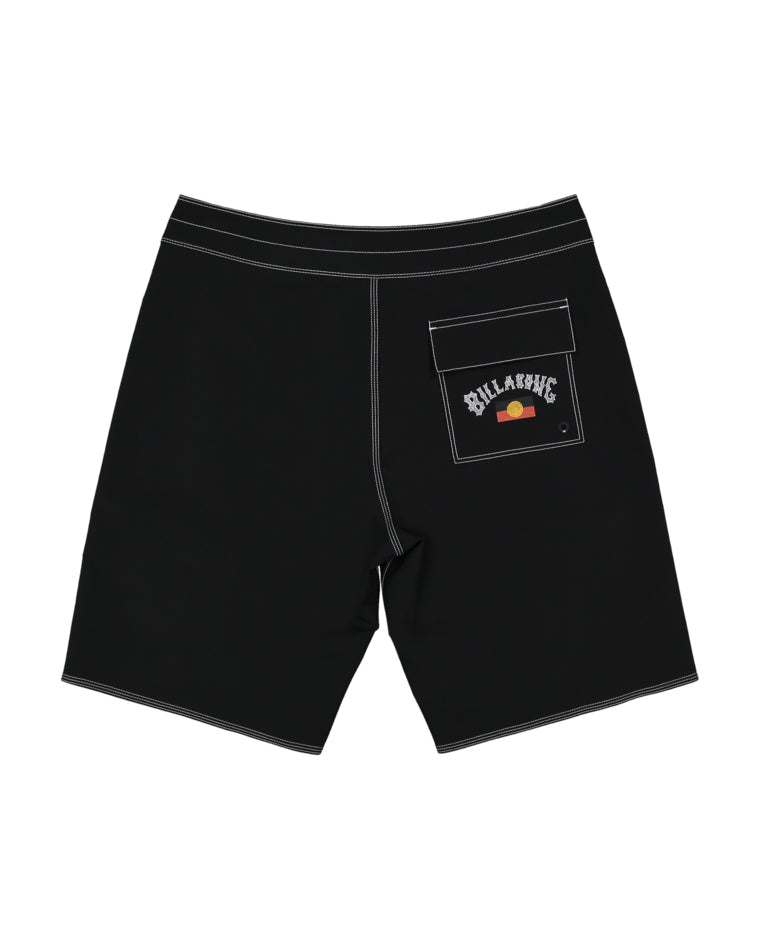 Back view of black boardshorts with white stitching and a flap pocket on the right, showcasing a Billabong logo patch with a stylised sunset graphic.
