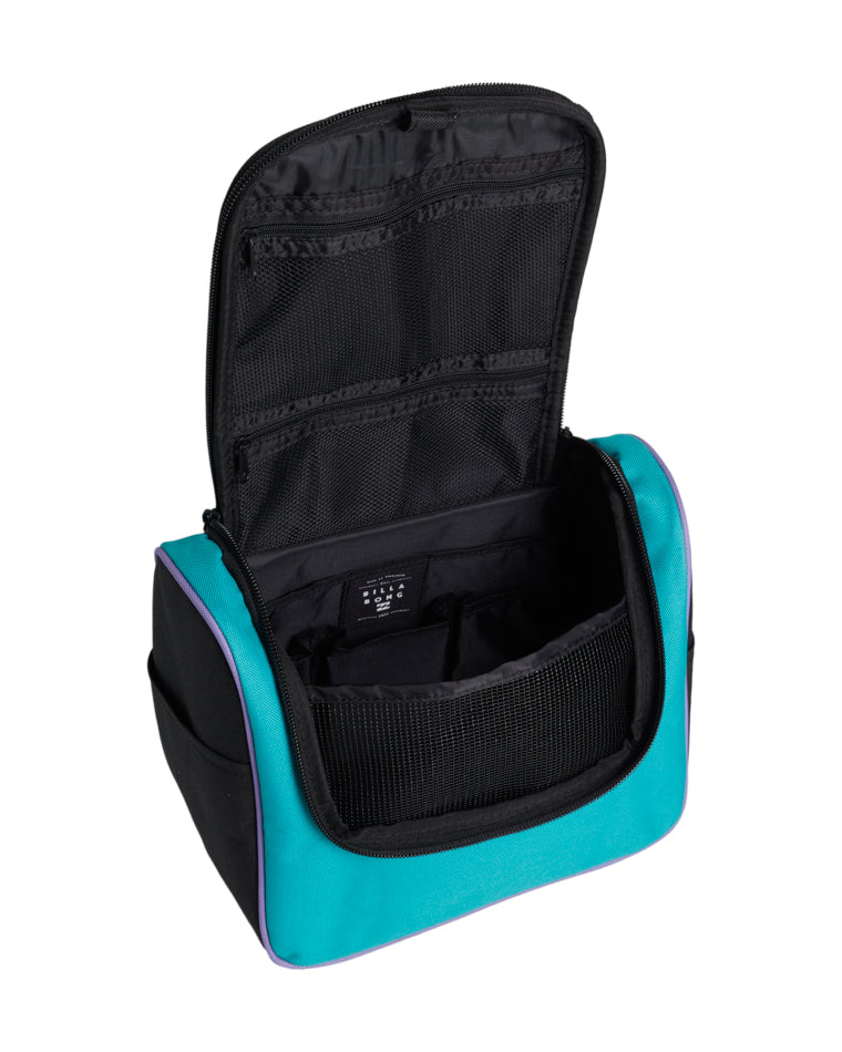 Open view of a Billabong travel bag showing interior compartments, mesh pockets, and zip sections, with teal outer panels and black lining.