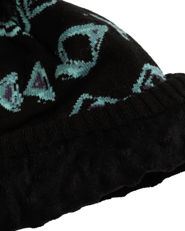 Close-up of a black beanie with teal geometric patterns, showing soft fleece lining and ribbed knit cuff for warmth and comfort.