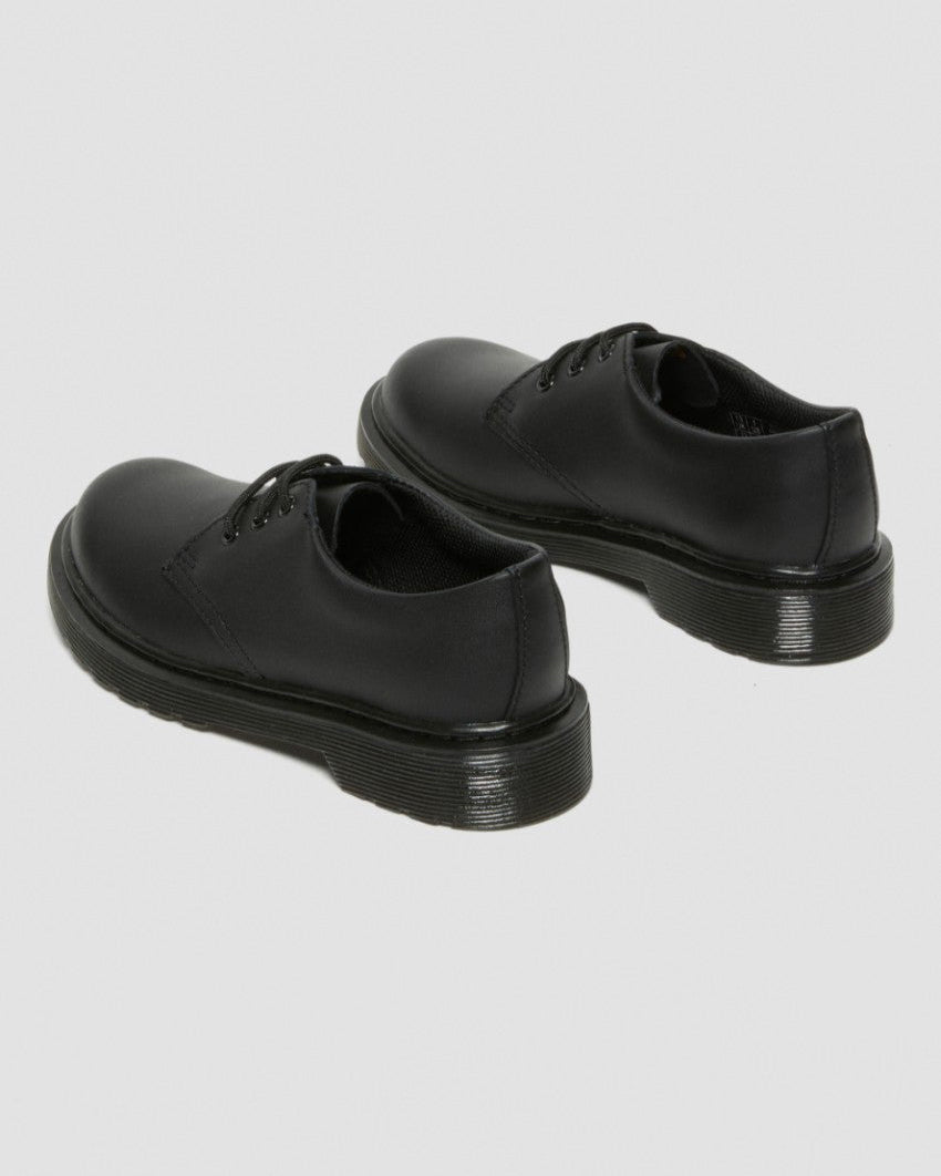 Back view of a pair of black lace-up shoes featuring smooth leather uppers, low-profile design, and durable grooved soles.