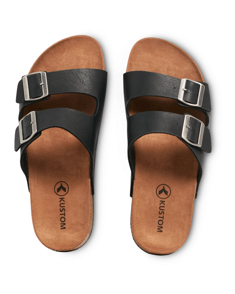 Top-down view of black double-strap men's slide sandals with Kustom logo on tan footbed.