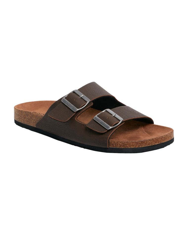Angled side view of a brown slide sandal featuring two adjustable buckle straps, a cork-look footbed, and a black outsole.