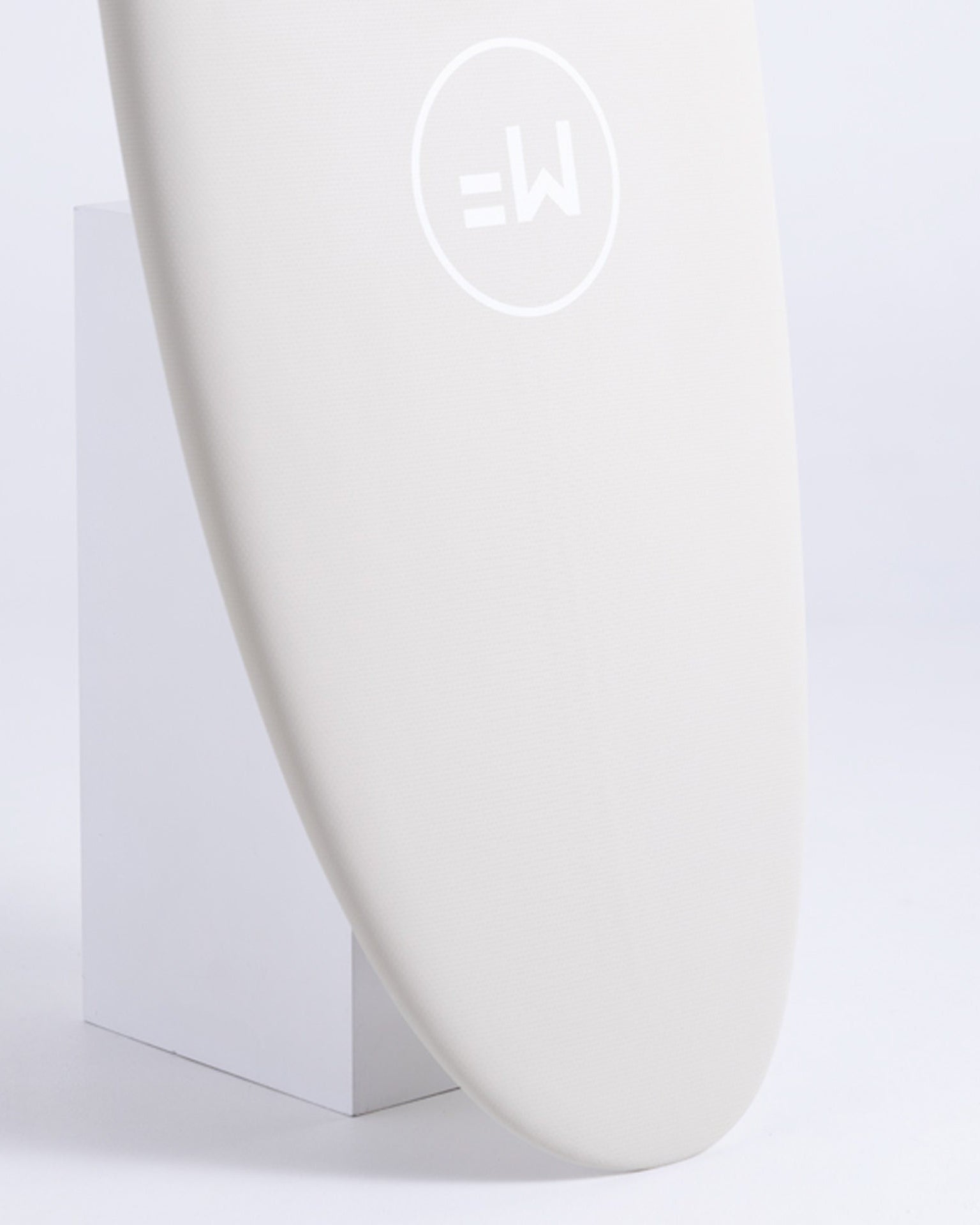 Close-up of the MF Beastie softboard nose with soft white finish and minimalist logo.