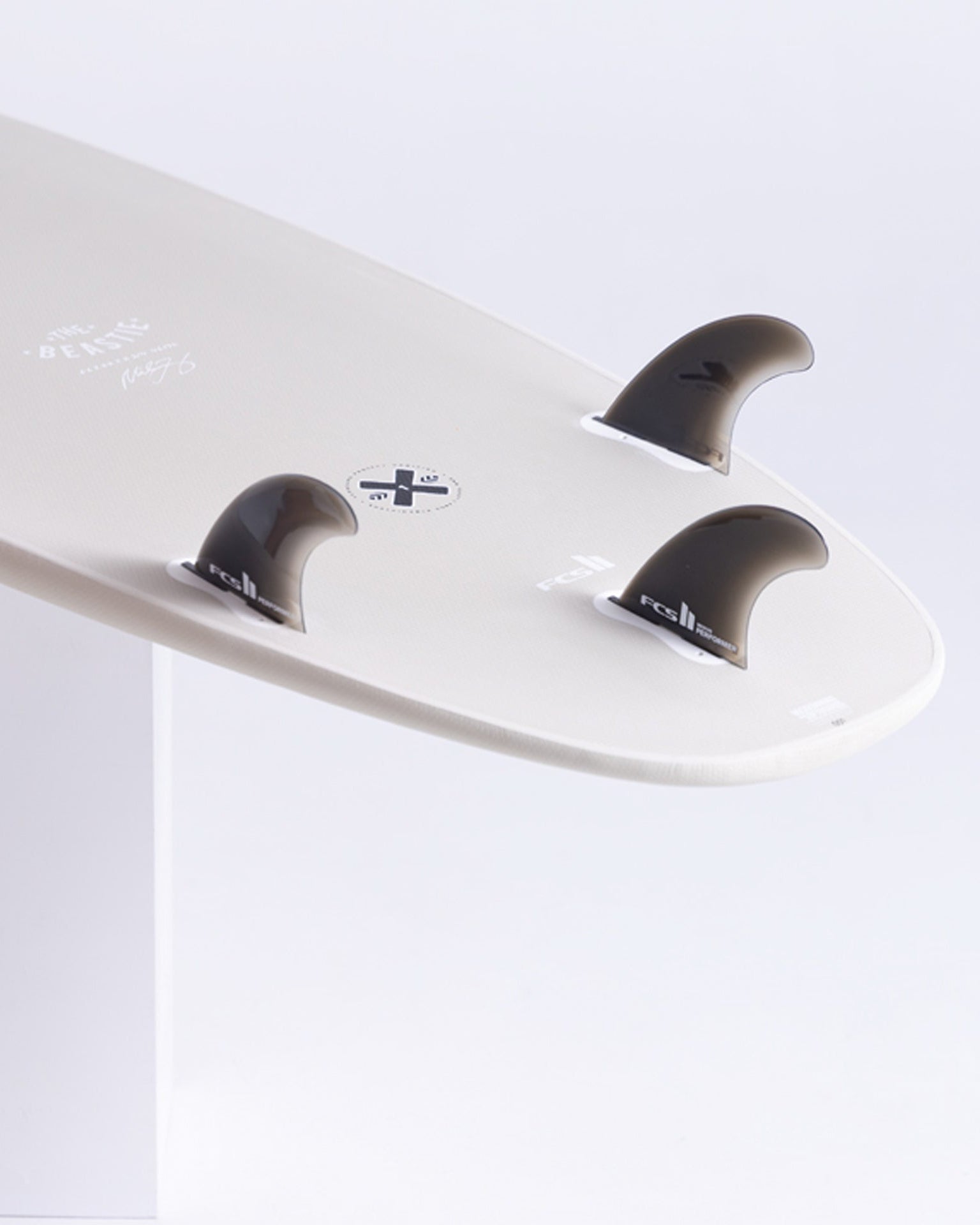 Detail shot of MF Beastie tail with FCS II fins and crosshair leash plug for secure attachment.
