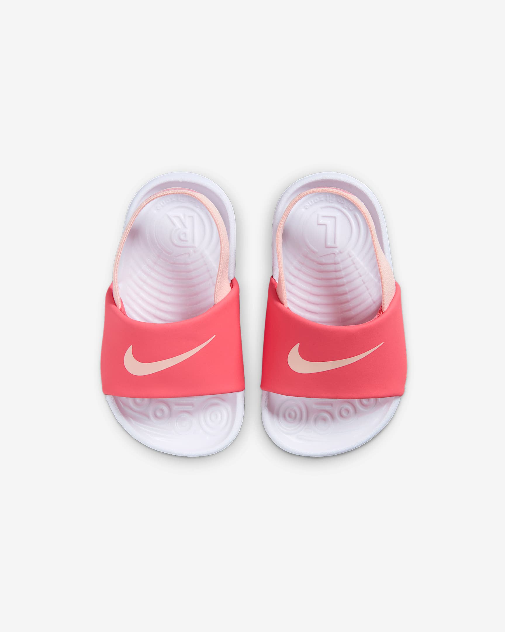 Top view of Nike toddler sandals in pink and white with moulded footbed and soft straps.