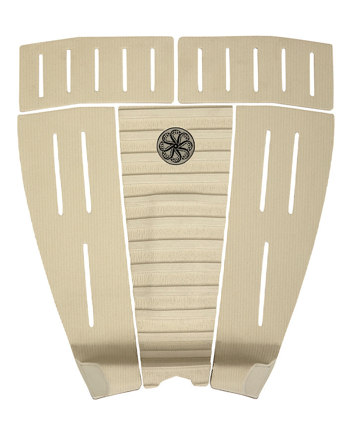 Beige 5-piece surfboard tail pad with centre arch, deep grooves, and vertical slits for traction