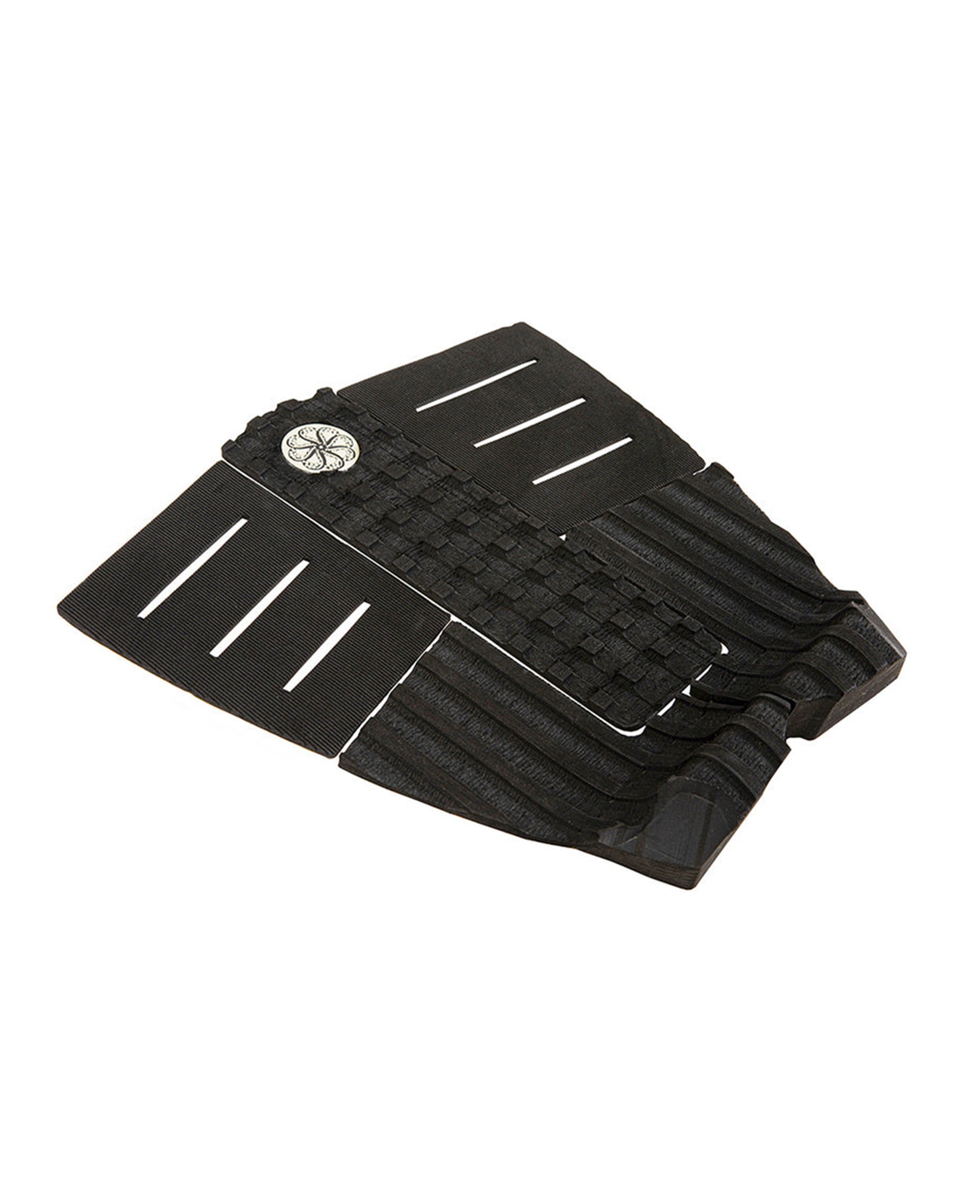 Angled view of black grip pad showing kick tail, slotted grooves, and textured checkerboard arch.