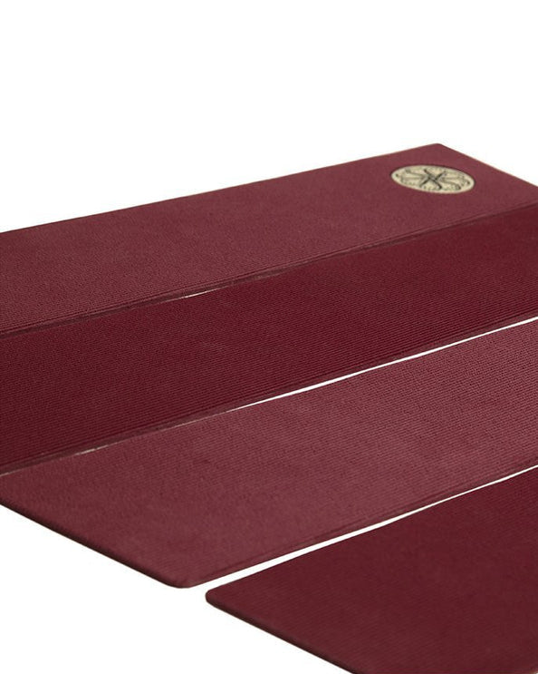 Side view of maroon deck grip showing flat arch design and clean finish.