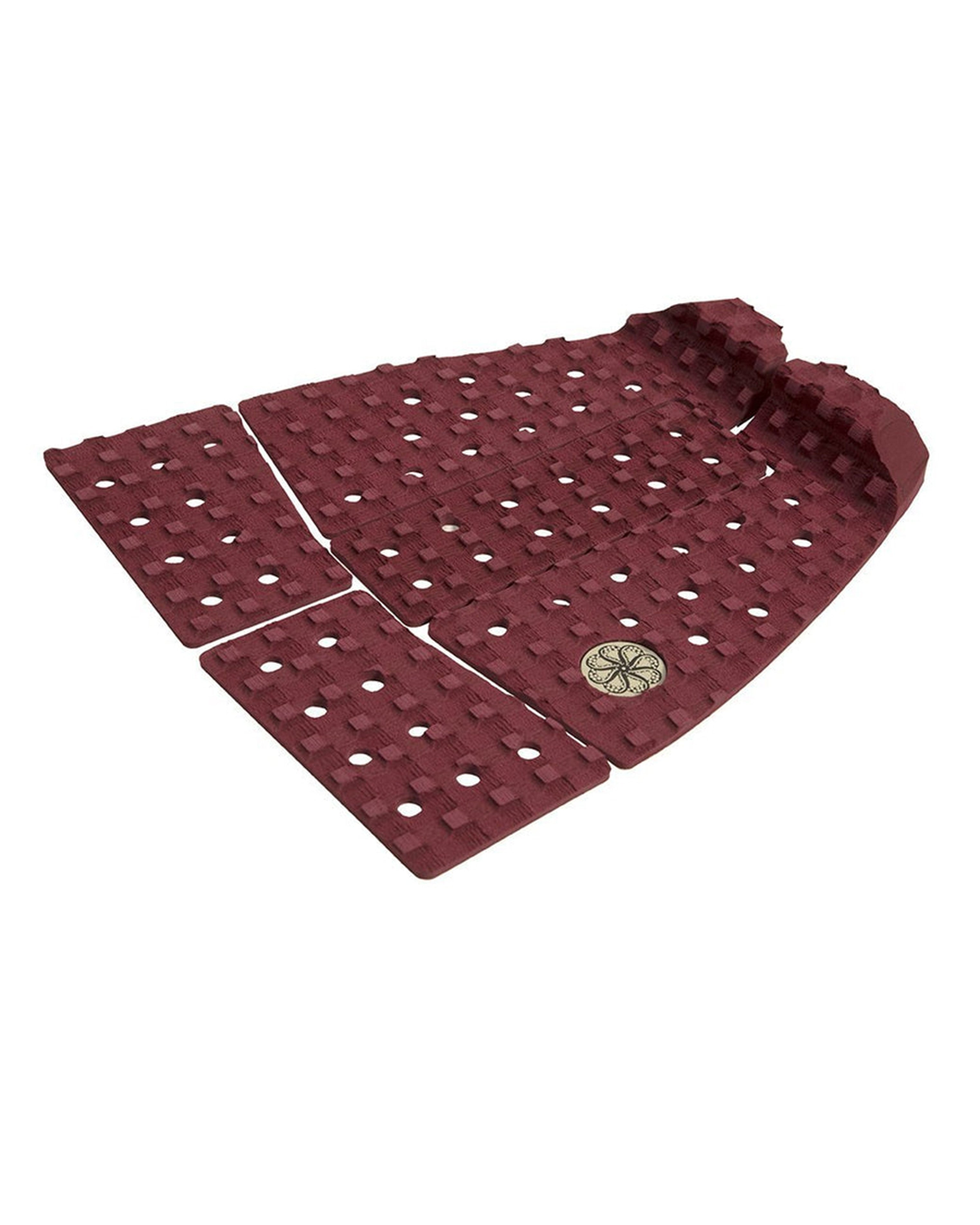 Rear angle of maroon surf pad with multi-piece design and circular logo.