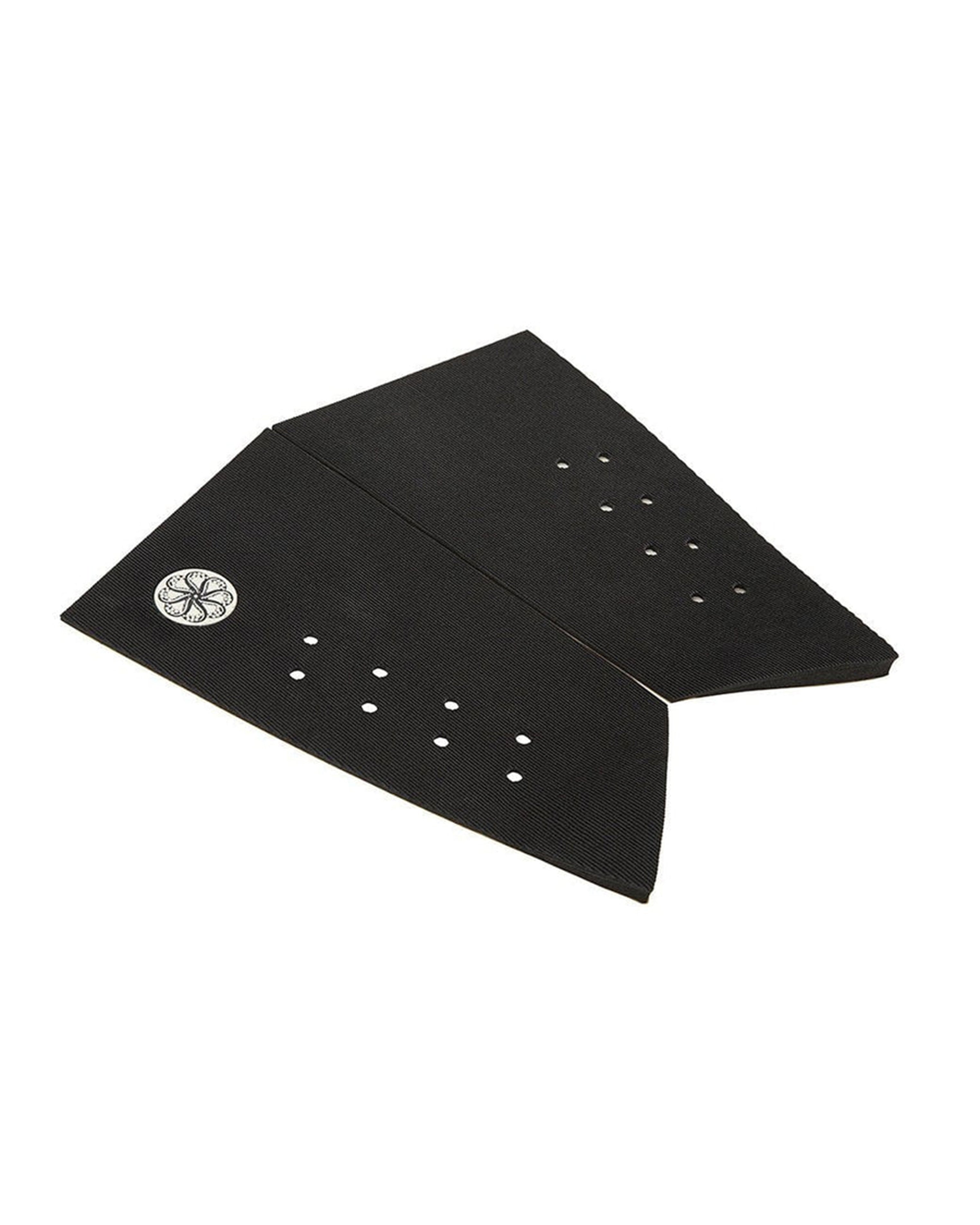 Angled view of black two-piece grip pad with textured ribbing and traction holes.