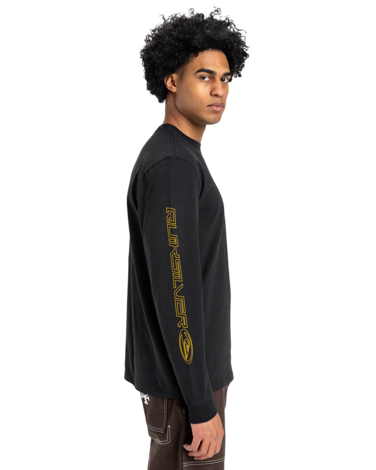Model wearing a black Quiksilver long-sleeve T-shirt with yellow logo text on the sleeve, shown in a side profile view.