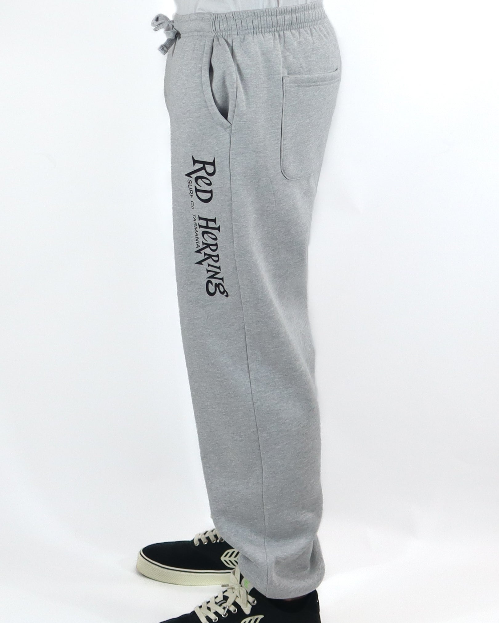 Side view of light grey Red Herring track pants with black logo detail.