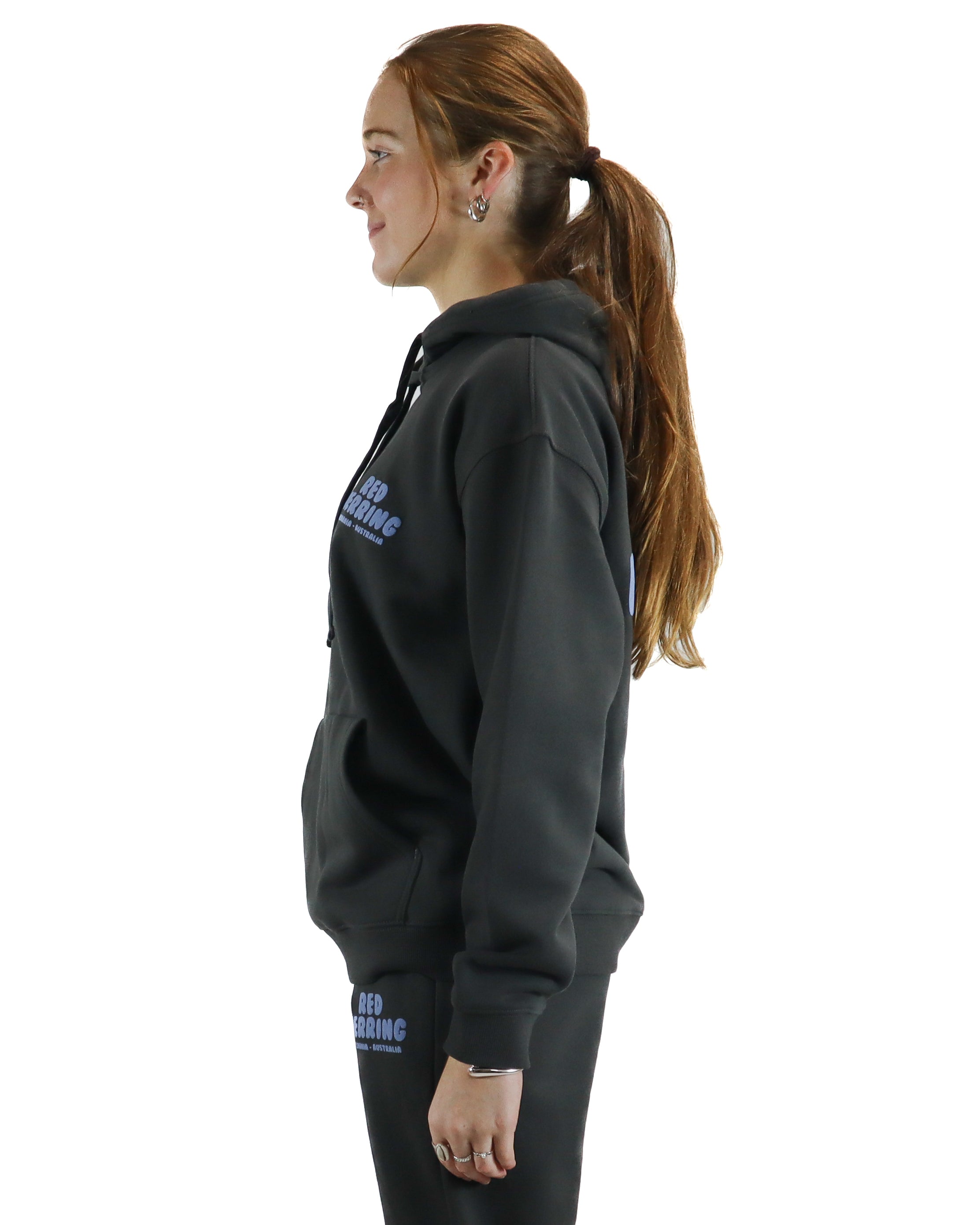 Side view of relaxed fit black hoodie with logo detail and drawstring hood