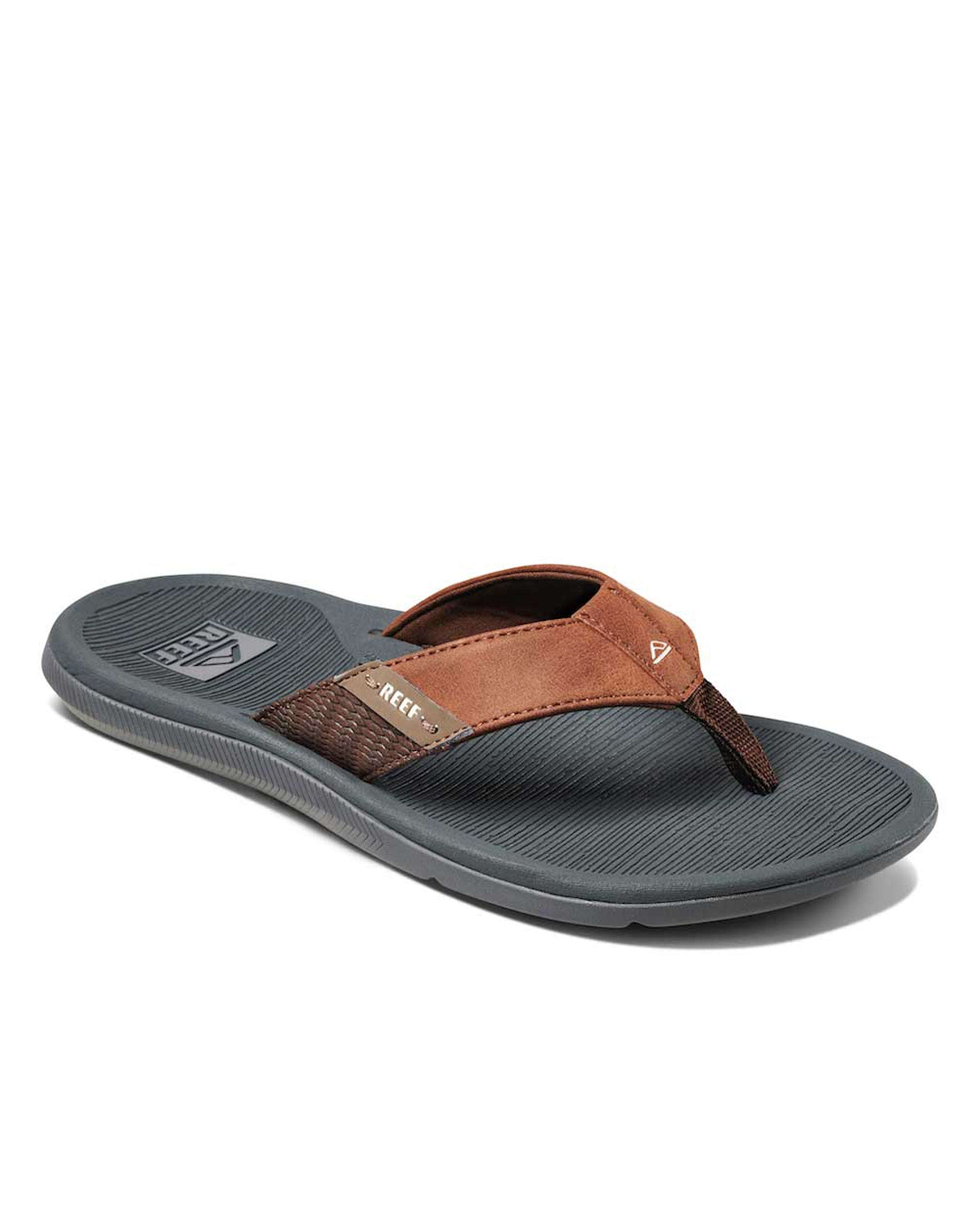 Angled view of Reef thong sandal with brown strap and grey sole.