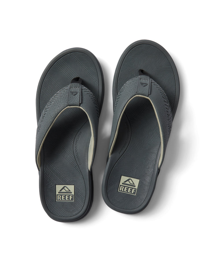 Top view of Reef grey sandals featuring wide straps and contoured footbed with logo detail