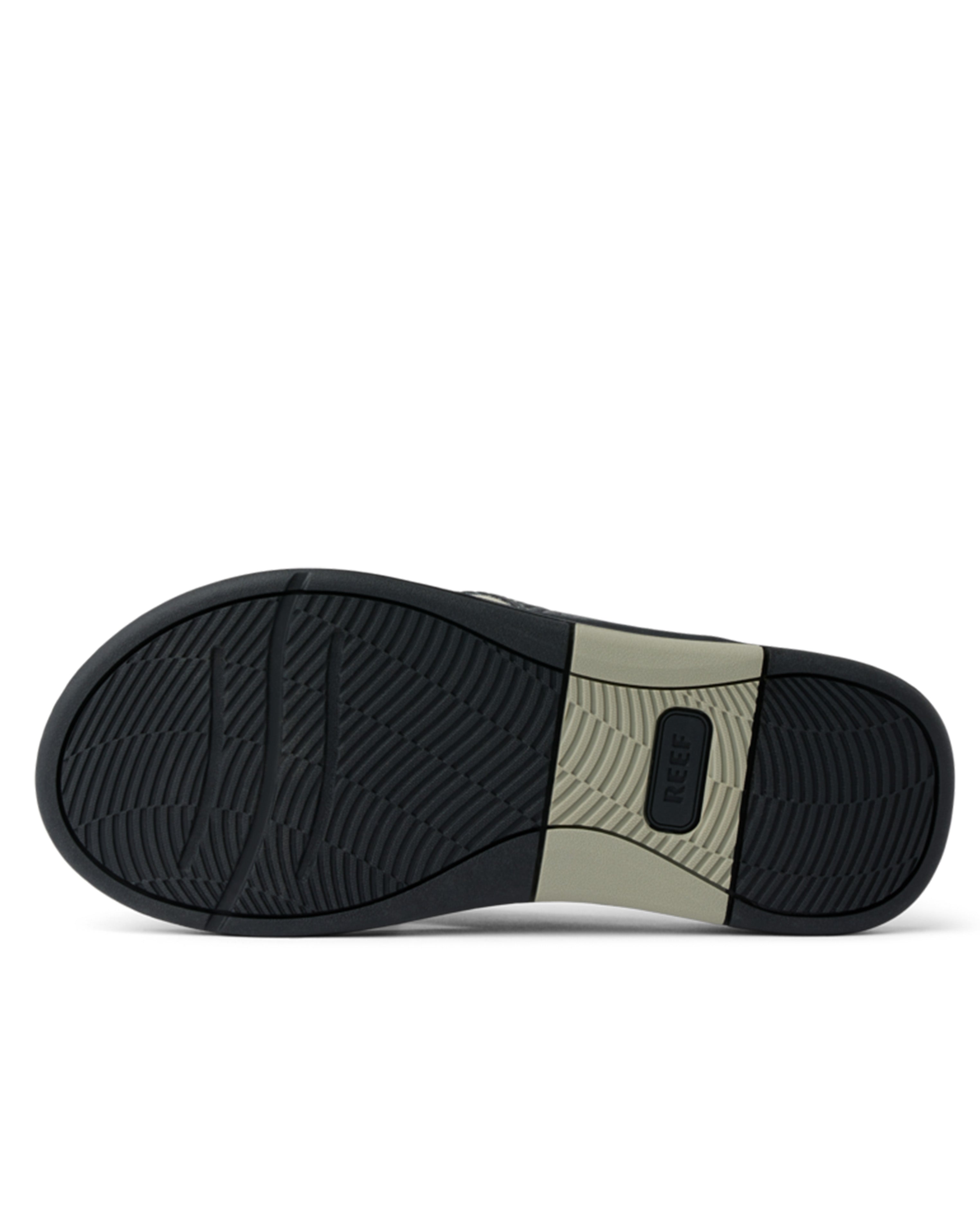 Bottom view of Reef sandal outsole with black and beige tread for traction and durability