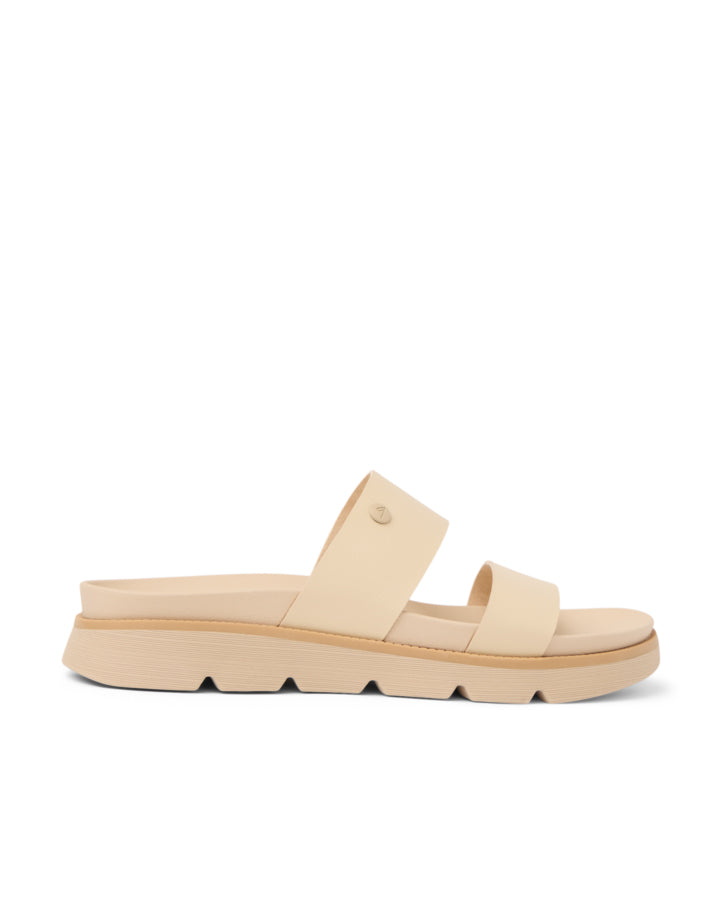 Side view of a beige double-strap slide sandal with a chunky sole and slight platform.