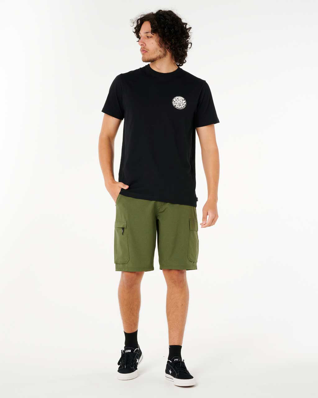 Casual outfit with olive cargo shorts, black graphic tee, black crew socks and black skate shoes.