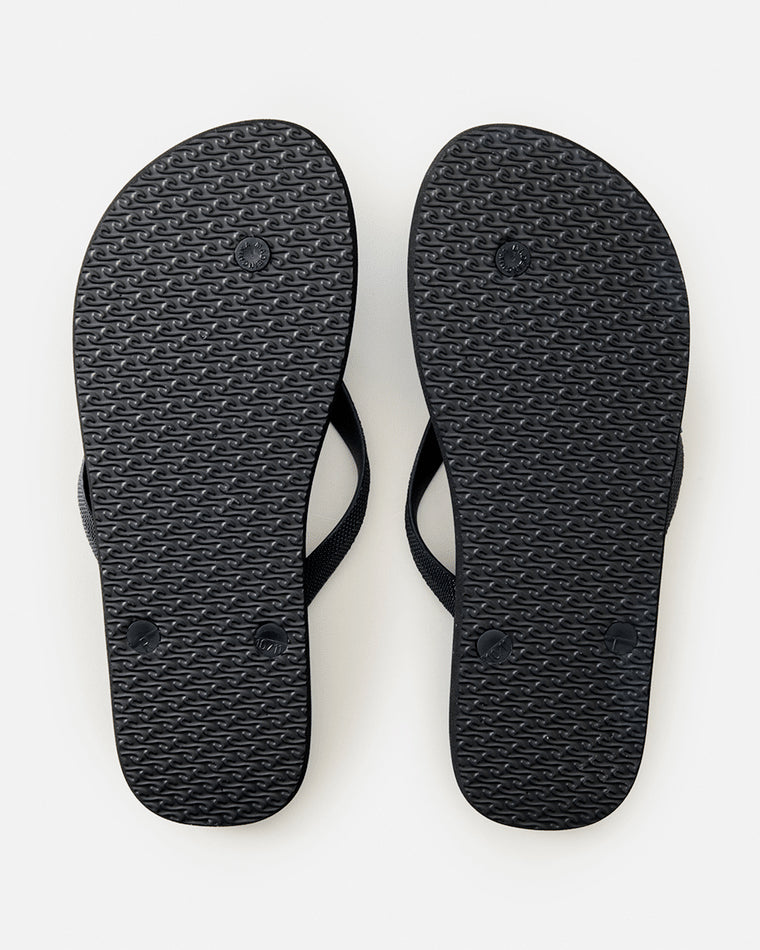 Bottom view of black Rip Curl thong soles with textured grip