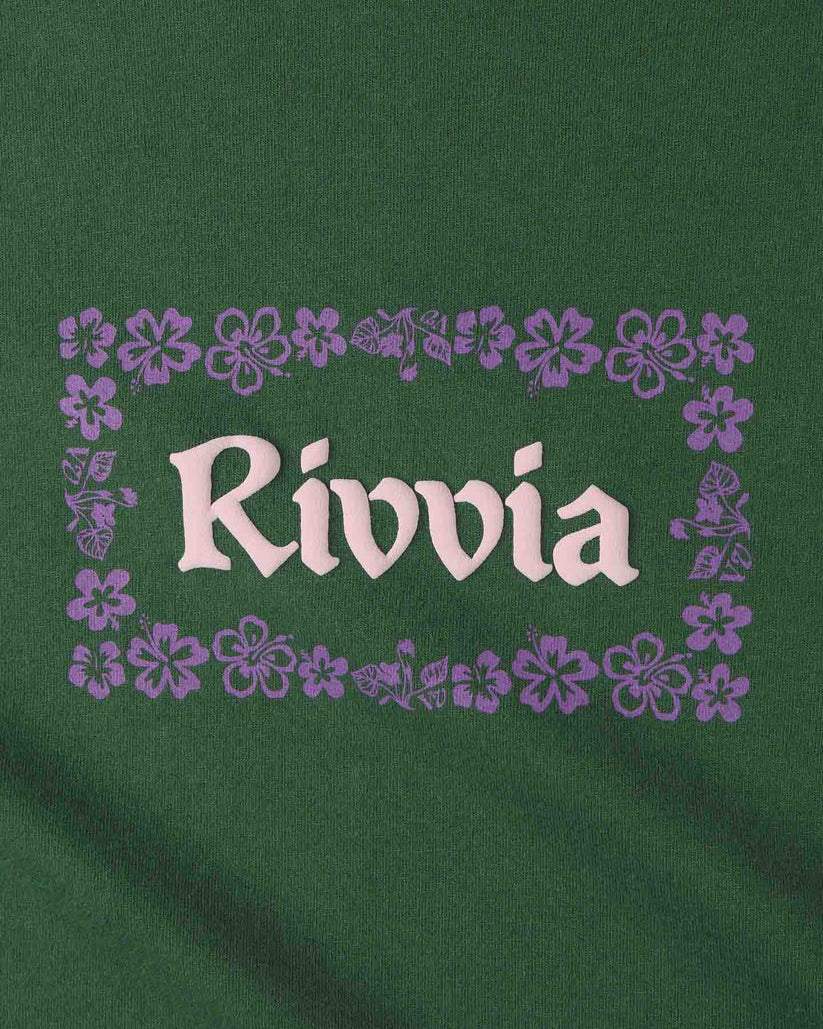Close-up of Rivvia logo in white with purple floral border on green fabric