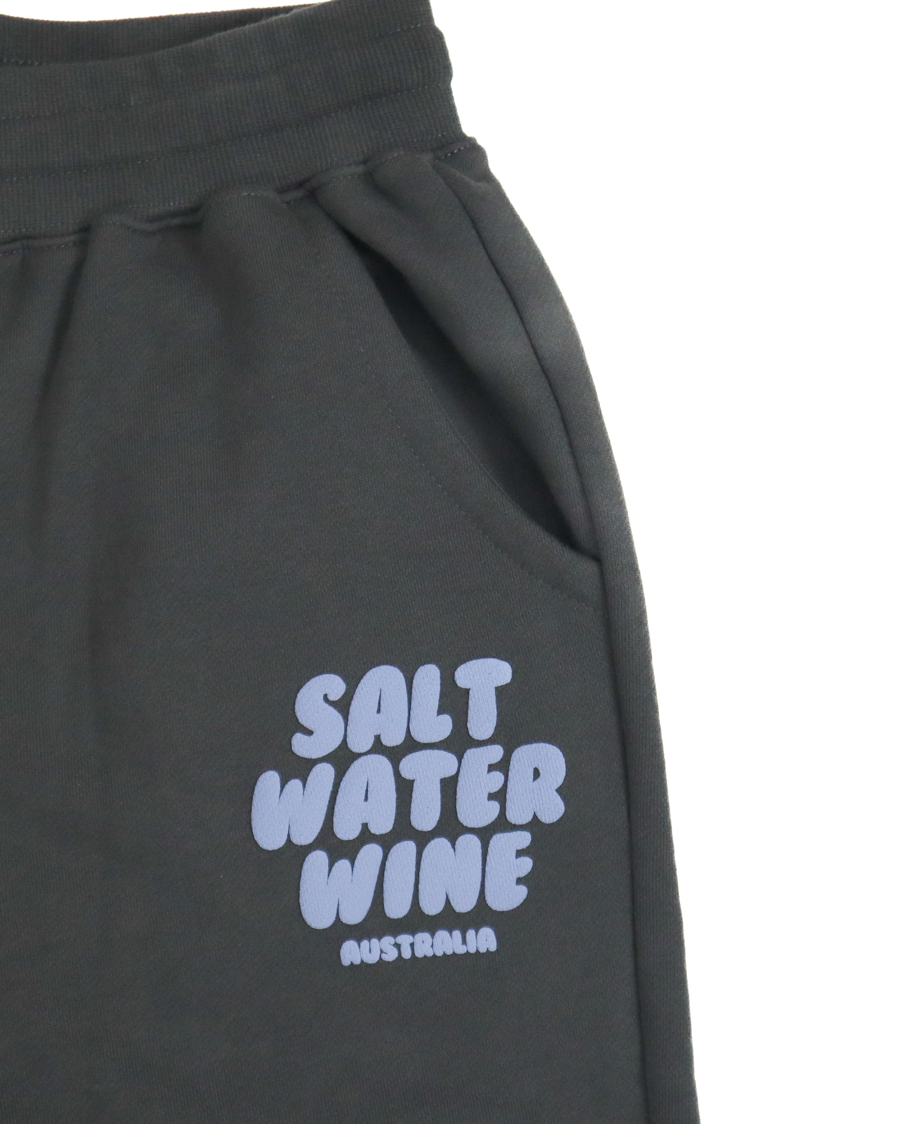 Close-up of Salt Water Wine Australia logo in lilac on charcoal fleece trackpants