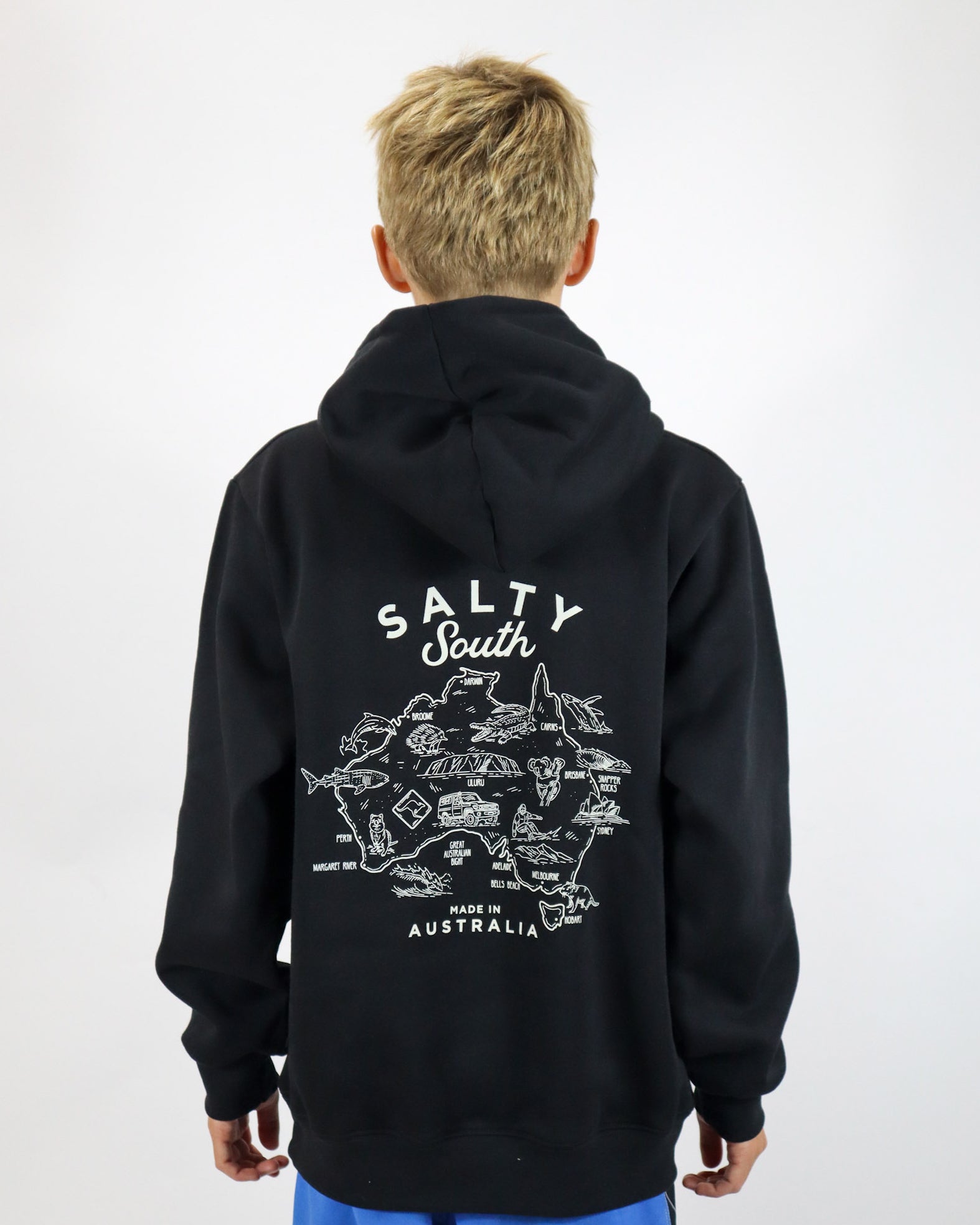 Studio shot of kids black Salty South hoodie with large Australia map print and Salty South branding on the back.