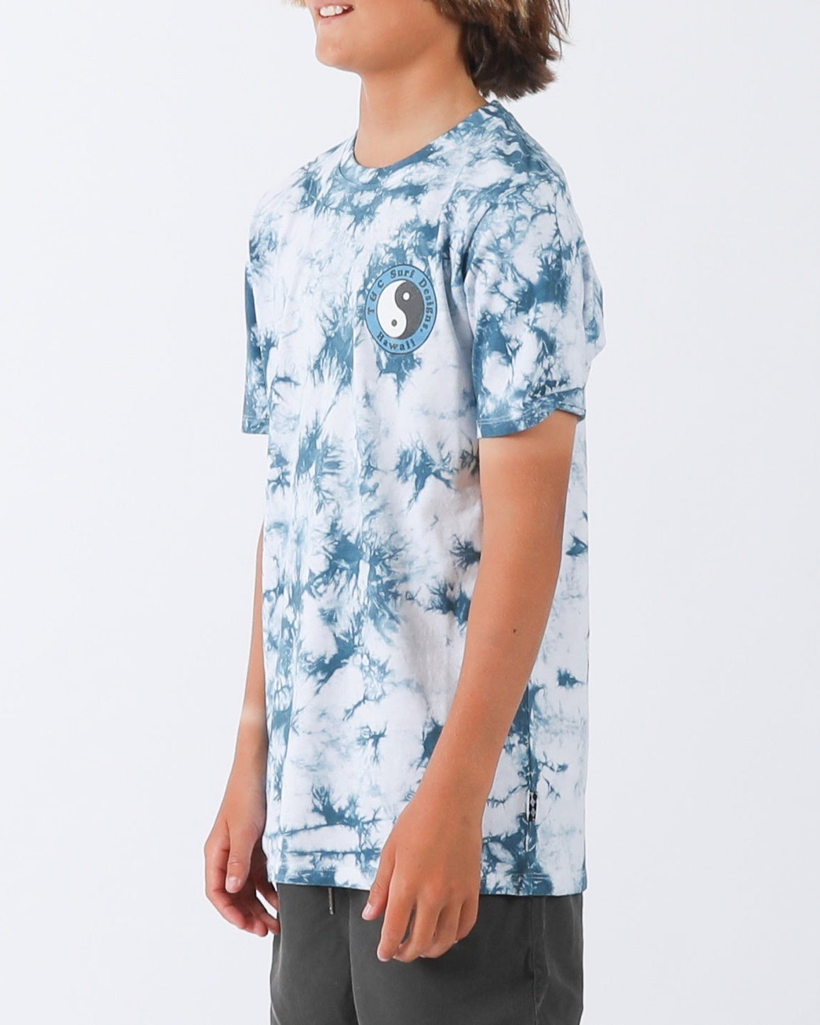 Blue and white tie-dye T-shirt featuring small yin-yang T&C Surf Designs Hawaii chest print, side view.