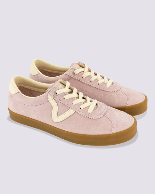 Angled front-side view of a pair of Vans sneakers in pink suede with cream accents, gum soles, and wave detailing on the sides.