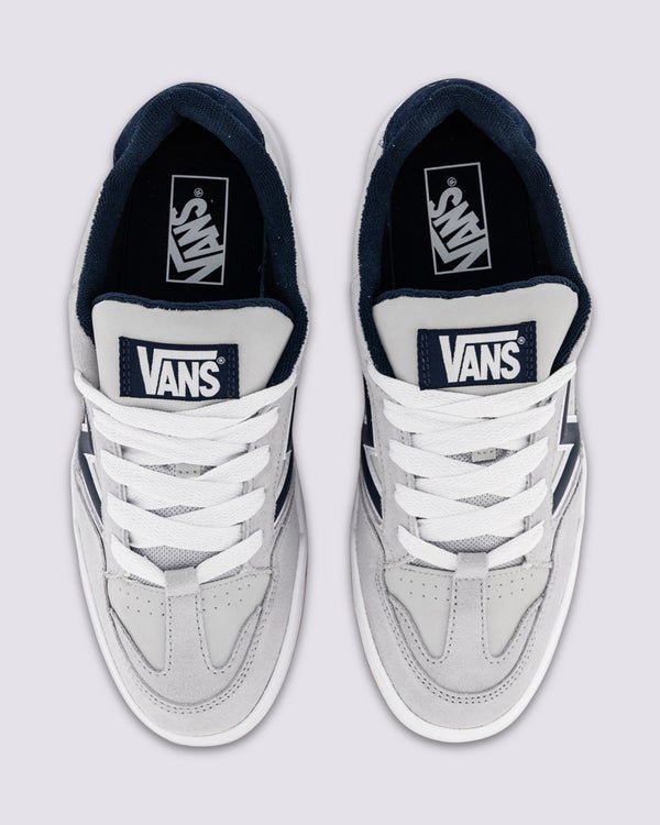 Top view of Vans grey sneakers with perforated toe box, white laces, and navy tongue branding.