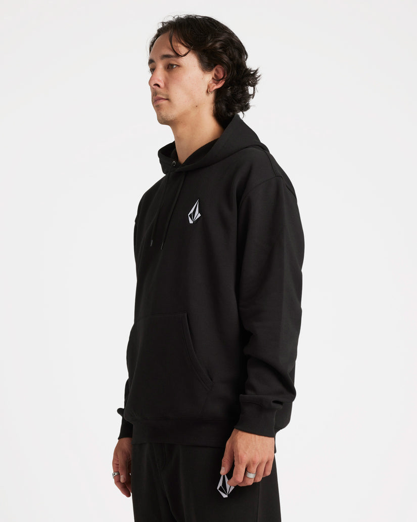 Side view of a model wearing a black Volcom hoodie with a small logo on the chest, kangaroo pocket, and relaxed fit.