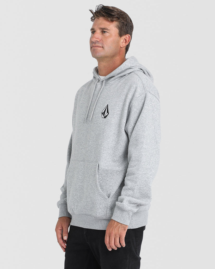 Male model wearing a light grey Volcom hoodie with a small black logo on the chest, kangaroo pocket, and ribbed cuffs and hem.