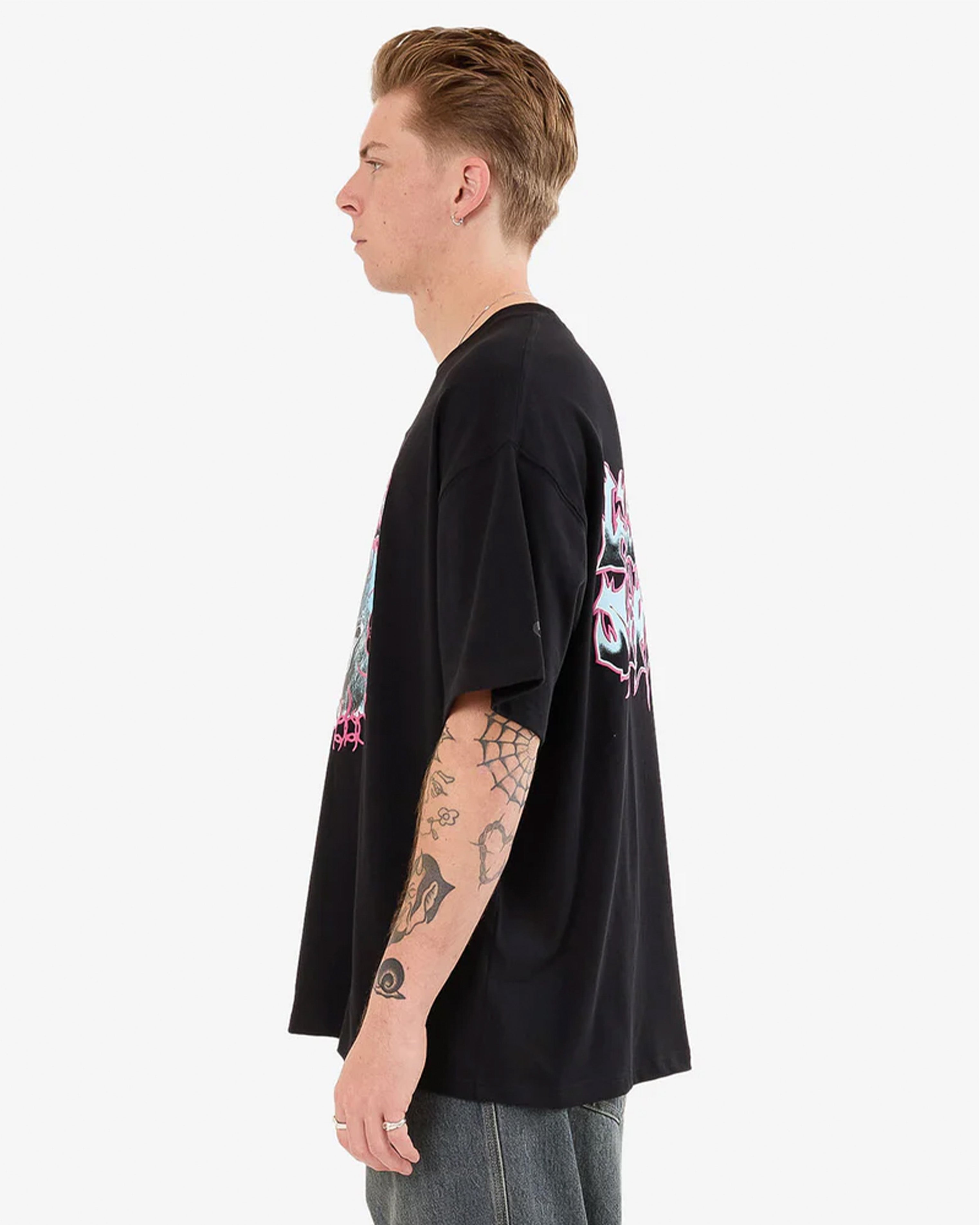 Side view of black oversized graphic tee with pink and blue front print