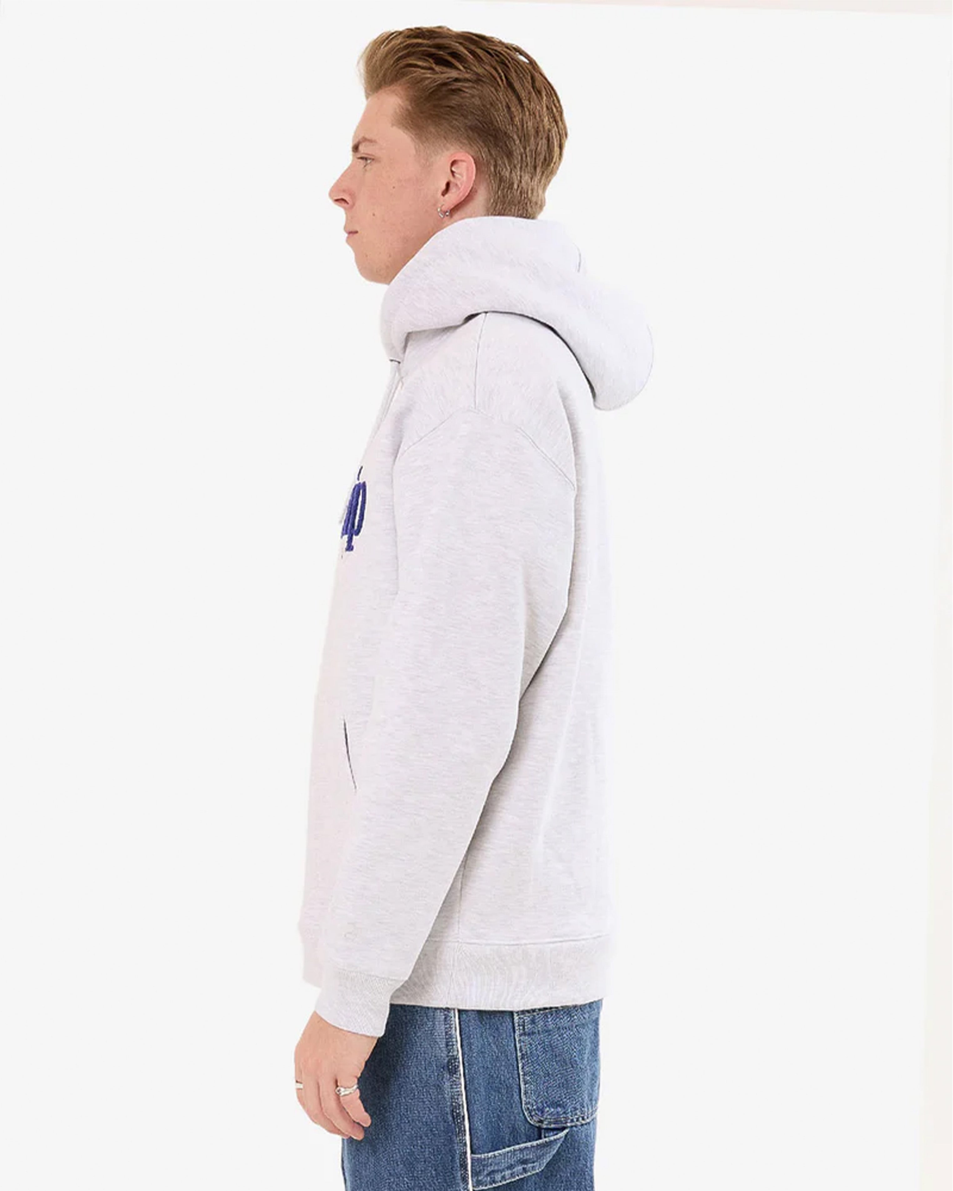 Side profile of light grey Worship hoodie showing oversized hood and relaxed drop-shoulder fit