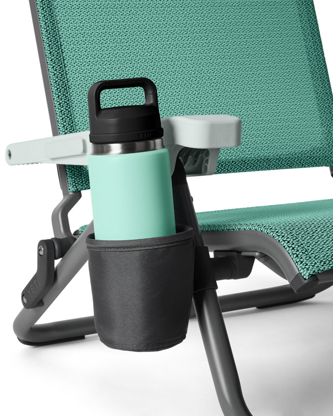 Close-up of YETI cup holder attached to chair leg with mint drink bottle inside.