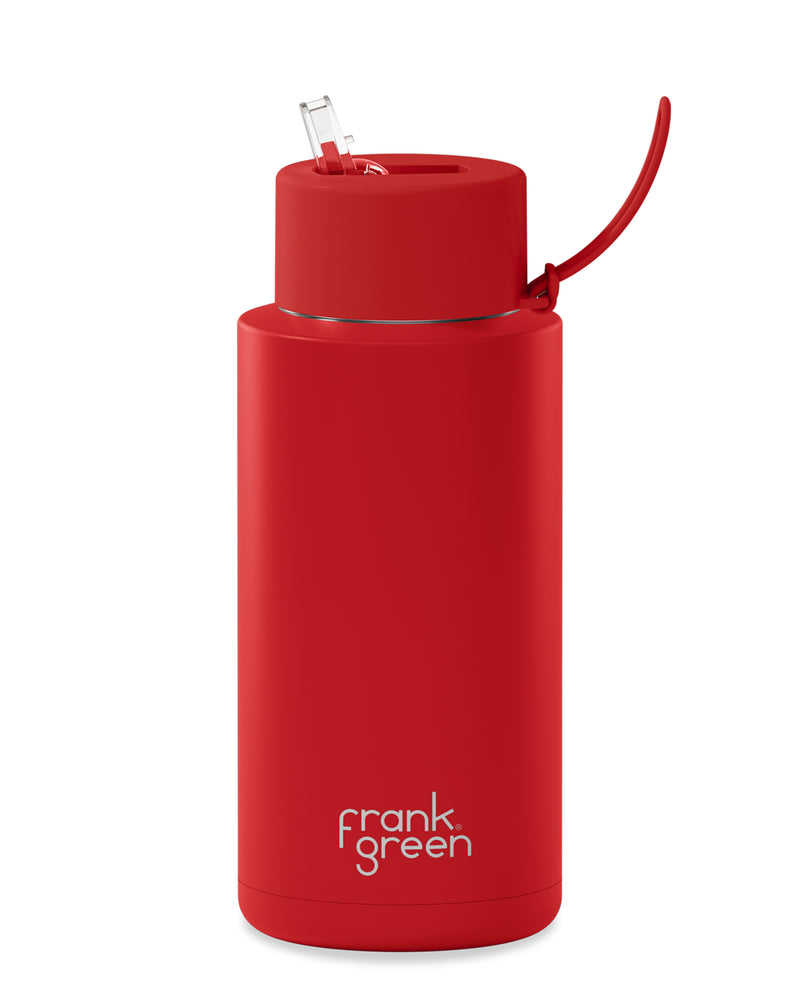 Bright red Frank Green water bottle featuring a sleek design, integrated straw lid, carry strap, and durable build.