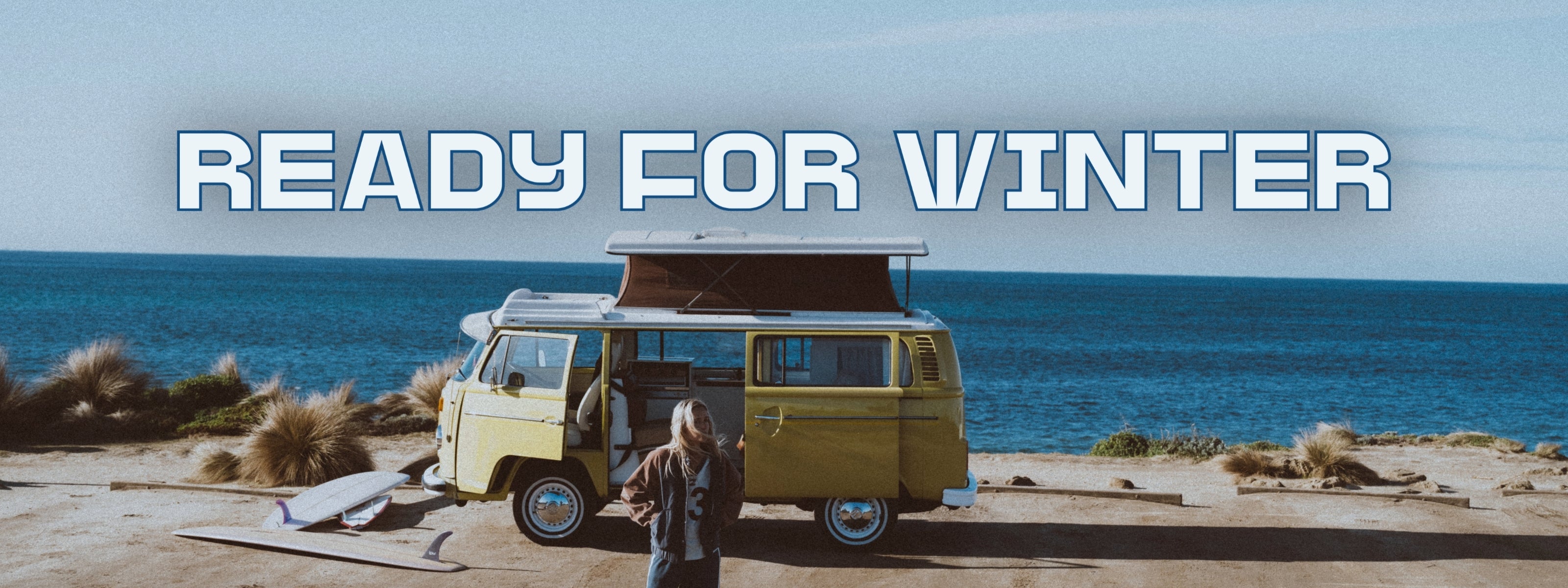 Vintage van by the ocean with 'Ready for Winter' text overlay