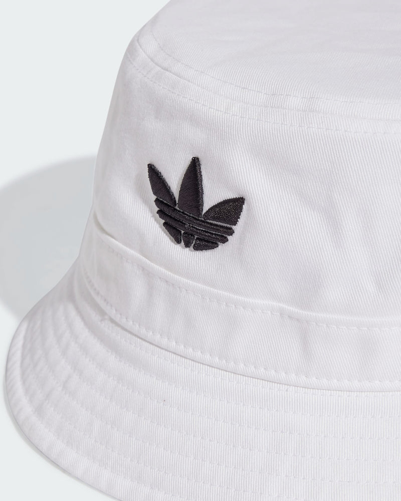 Close-up of white adidas bucket hat featuring stitched brim and black Trefoil logo detail on the crown.