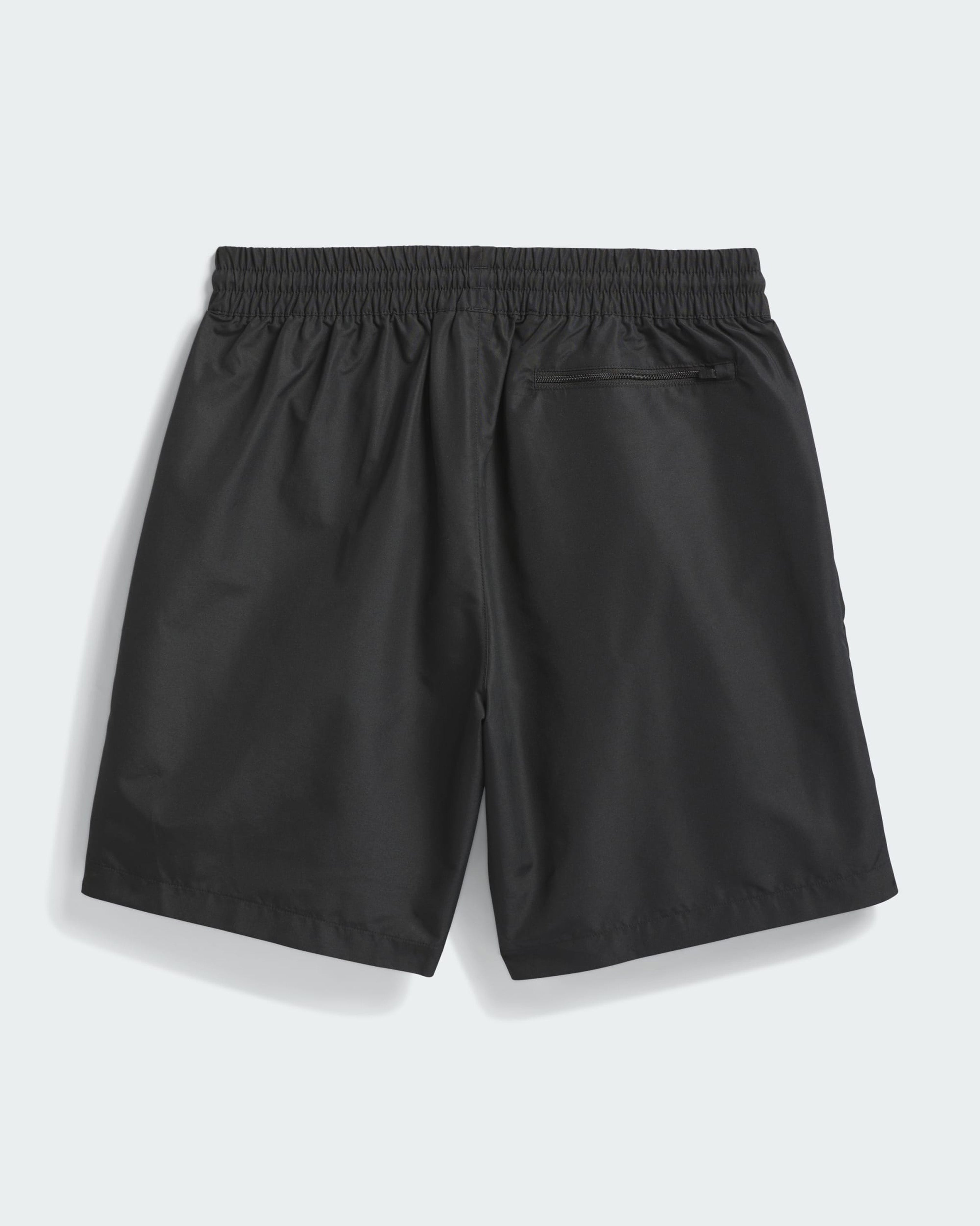 Back view of black Adidas shorts with elastic waist and zippered pocket on right side