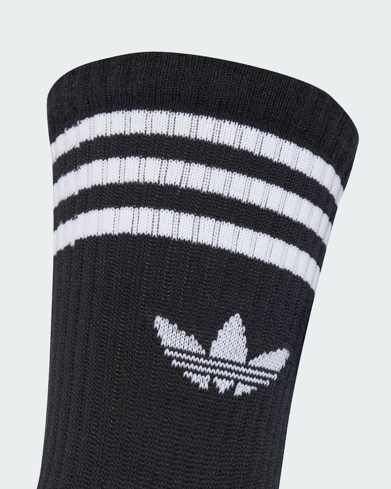 Detail of adidas crew sock cuff with white trefoil logo and triple stripe design for a classic sporty look.