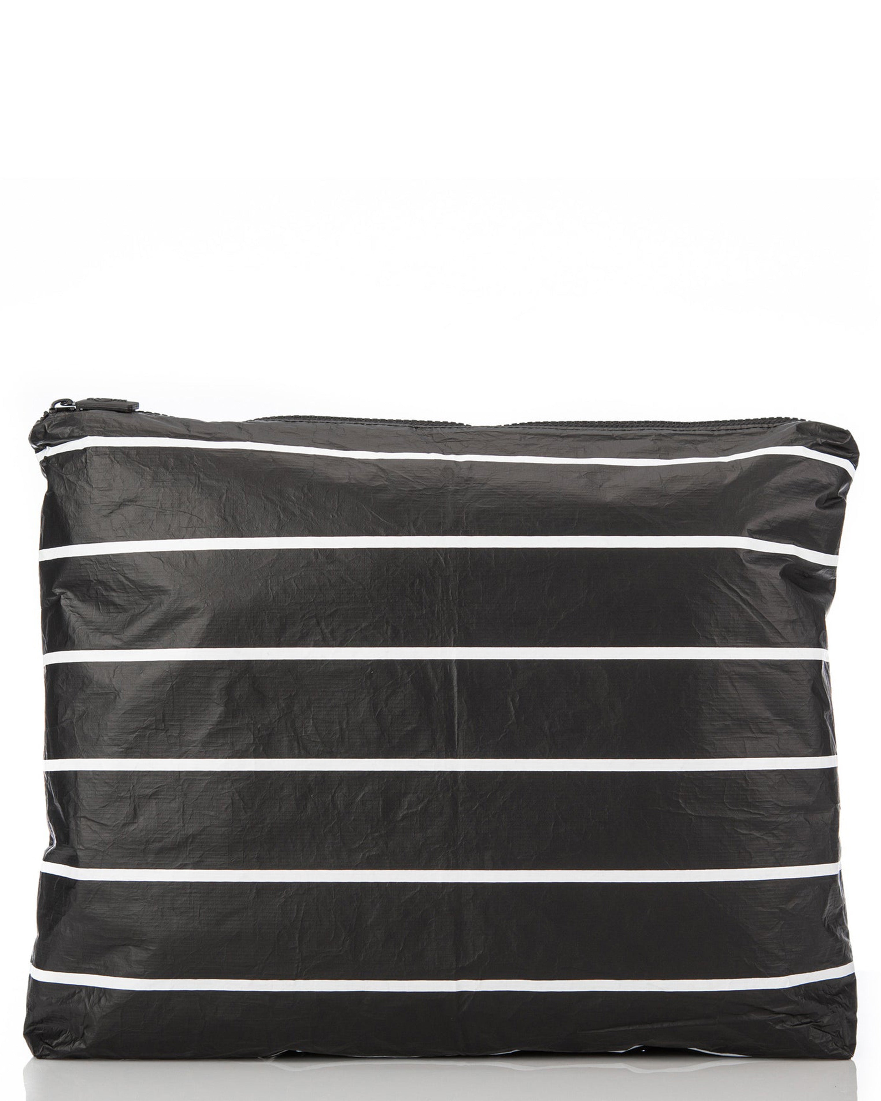 Black zip pouch with white horizontal stripes, made from crinkled material and ideal for beach or travel essentials.