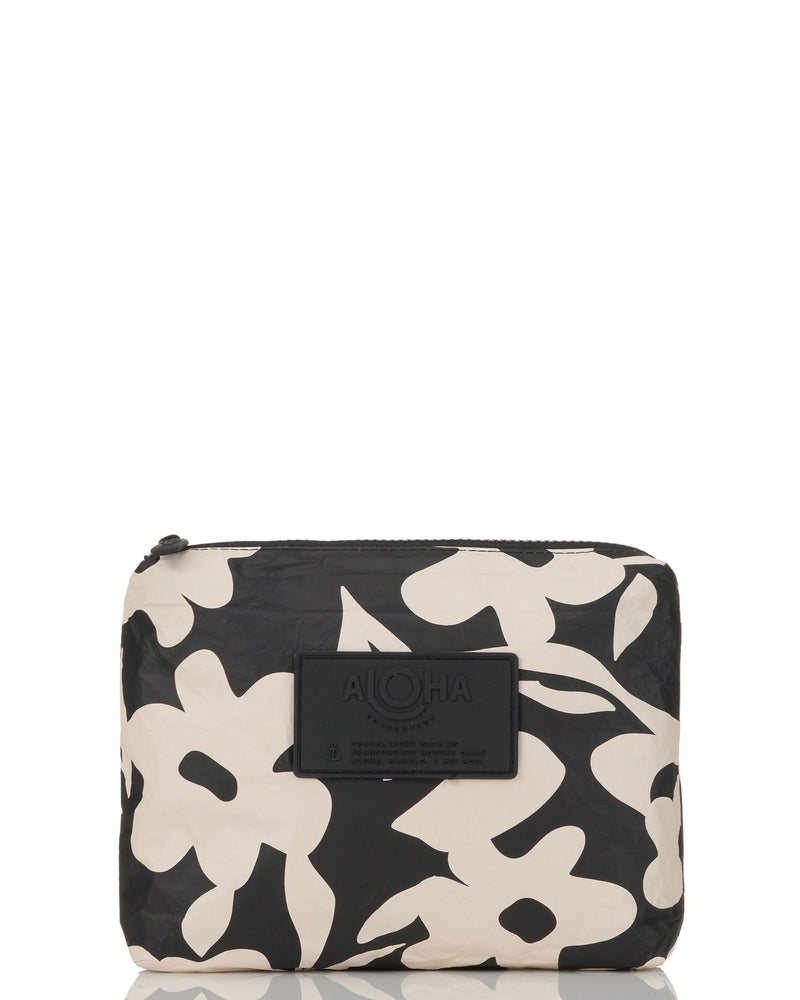Black and cream ALOHA pouch with bold floral print and black logo patch on the front