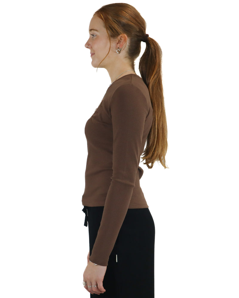 Side view of brown ribbed long sleeve top showing slim fit and long sleeves