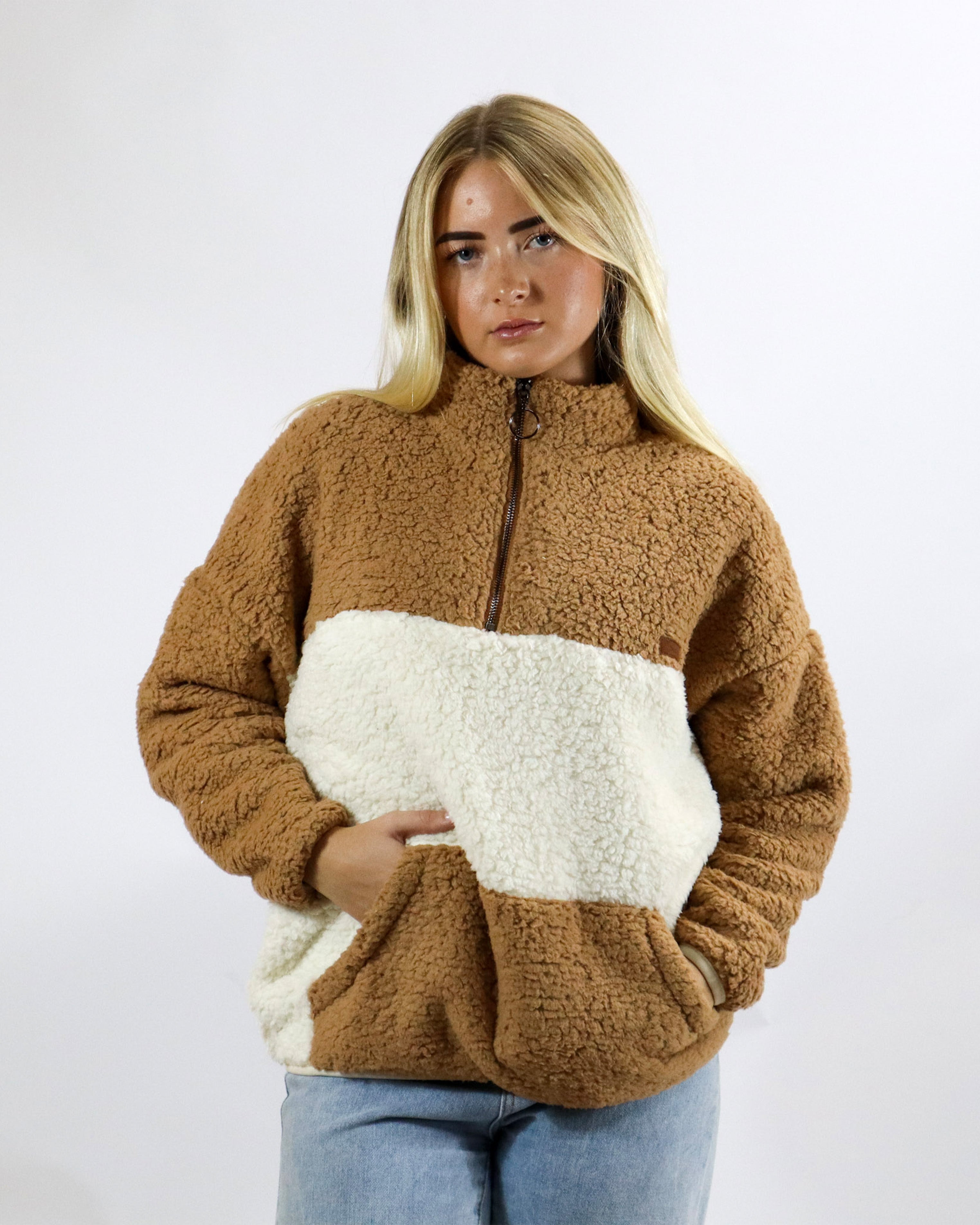 Two-tone brown and cream sherpa fleece with half zip and kangaroo pocket, perfect for winter layering.