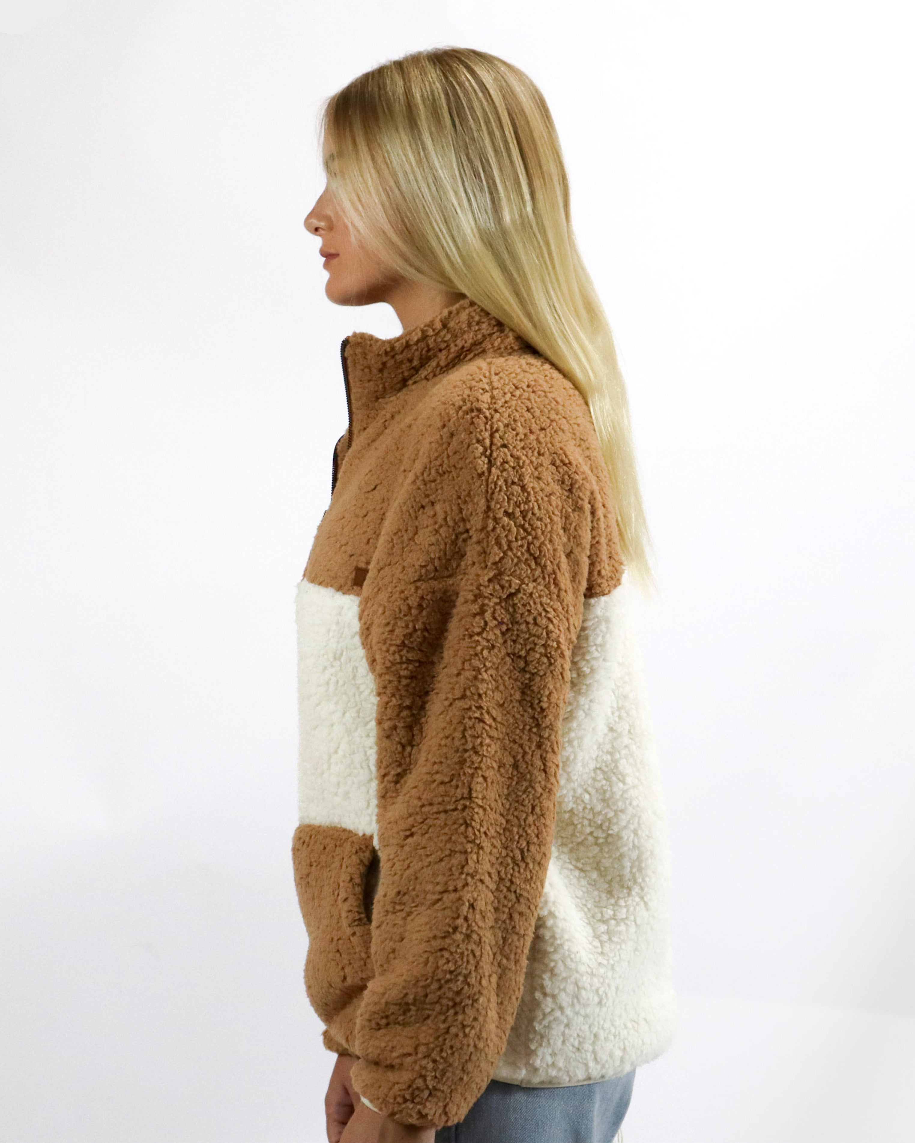 Side view of soft colour-block fleece with high neck and cosy textured finish for added warmth.