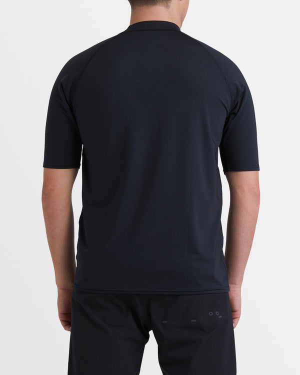Back view of black Billabong rash vest with raglan sleeves and streamlined surf silhouette