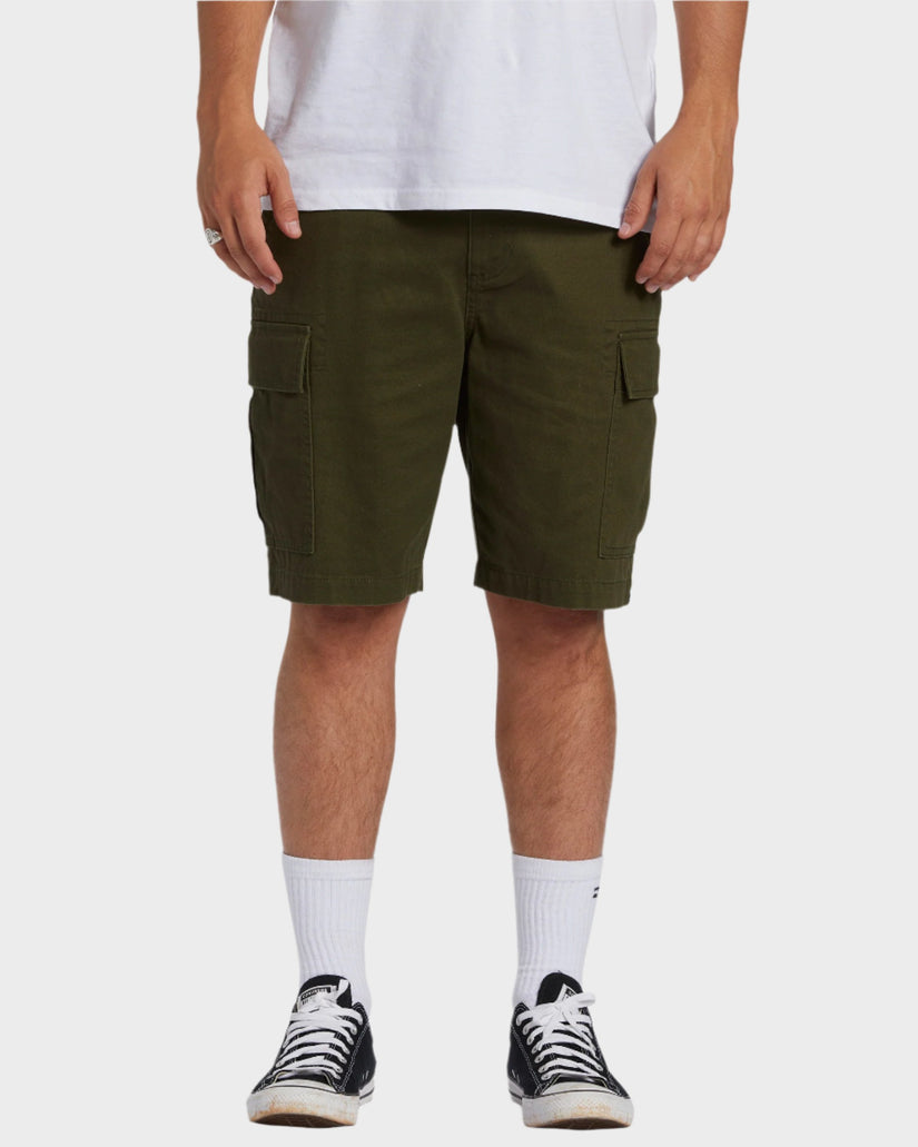 Men's olive green cargo shorts with front patch pockets, styled with black Converse and white socks.