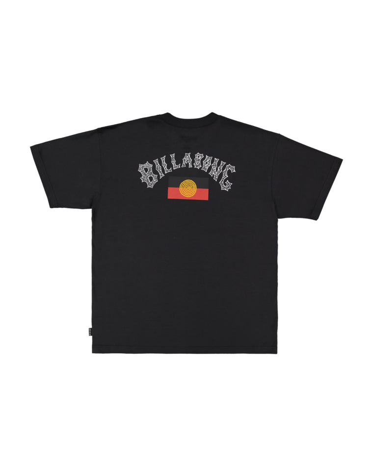 Back of black Billabong t-shirt featuring large Billabong logo in white with Indigenous-style detailing above a red and yellow sun graphic.
